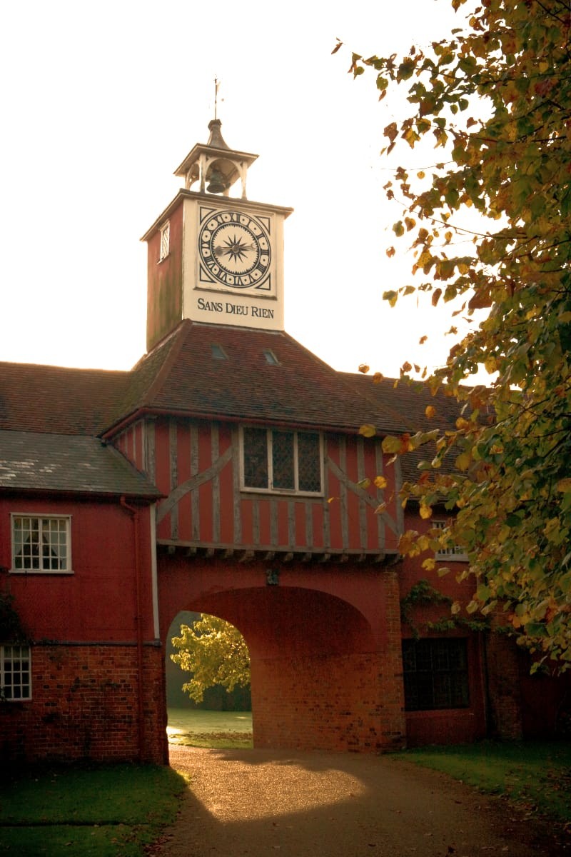 Looking through the gatehouse arch towards the house at sunset