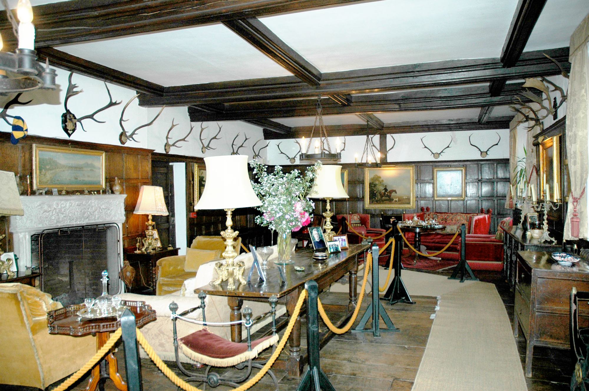 A panelled sitting room with an open fireplace
