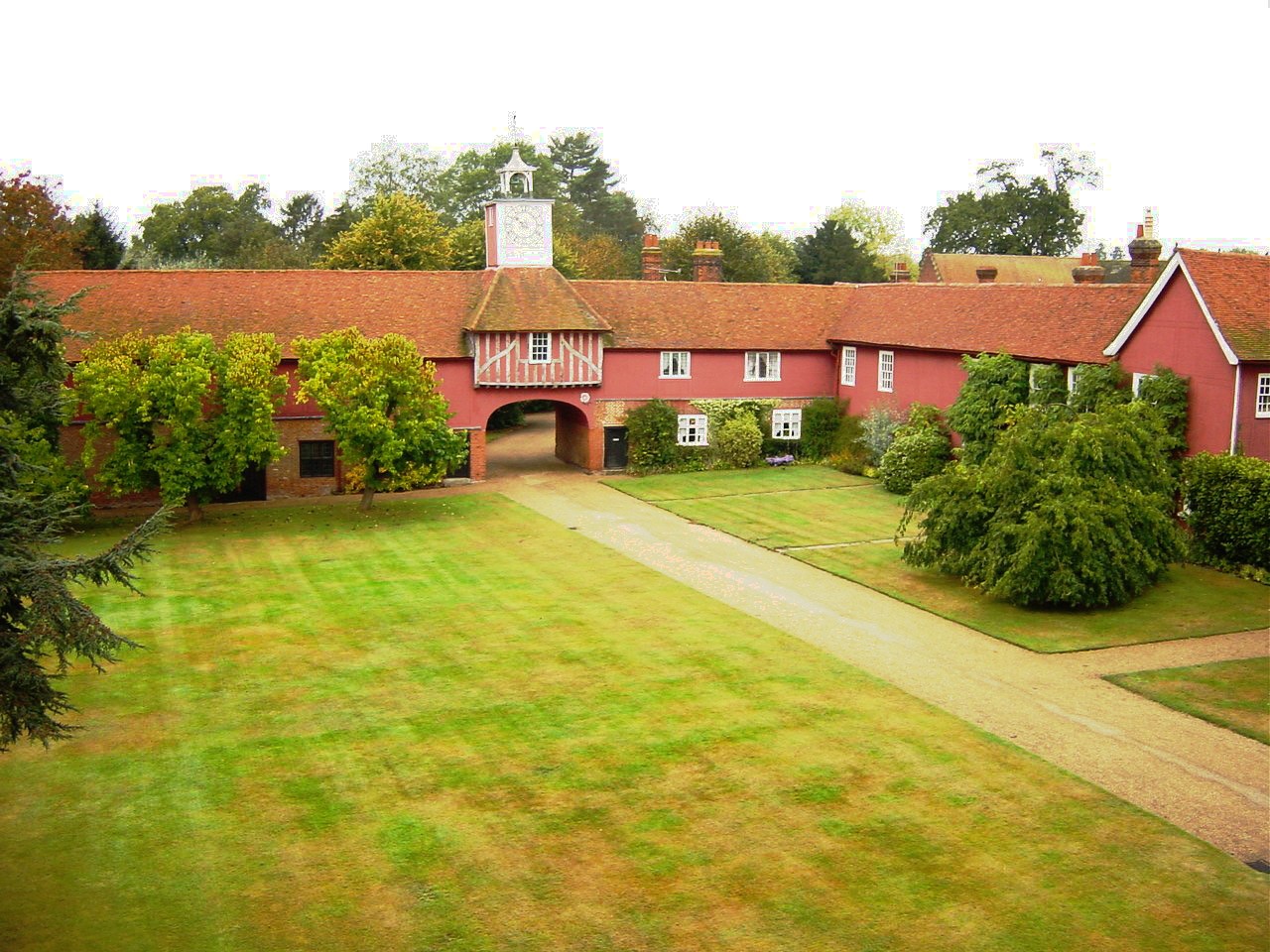 The gatehouse with its one-handed clock, seen from the drive