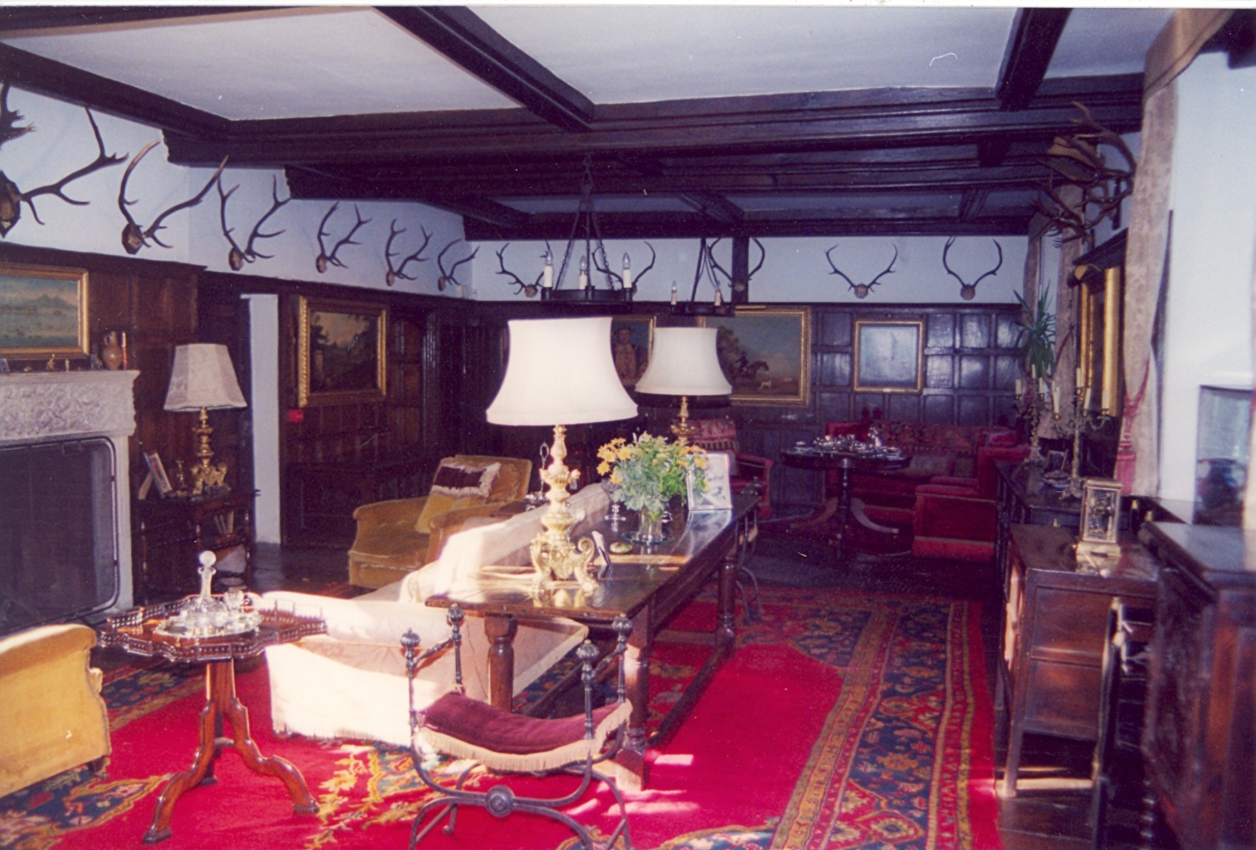 A sitting room with lamps and a red carpet